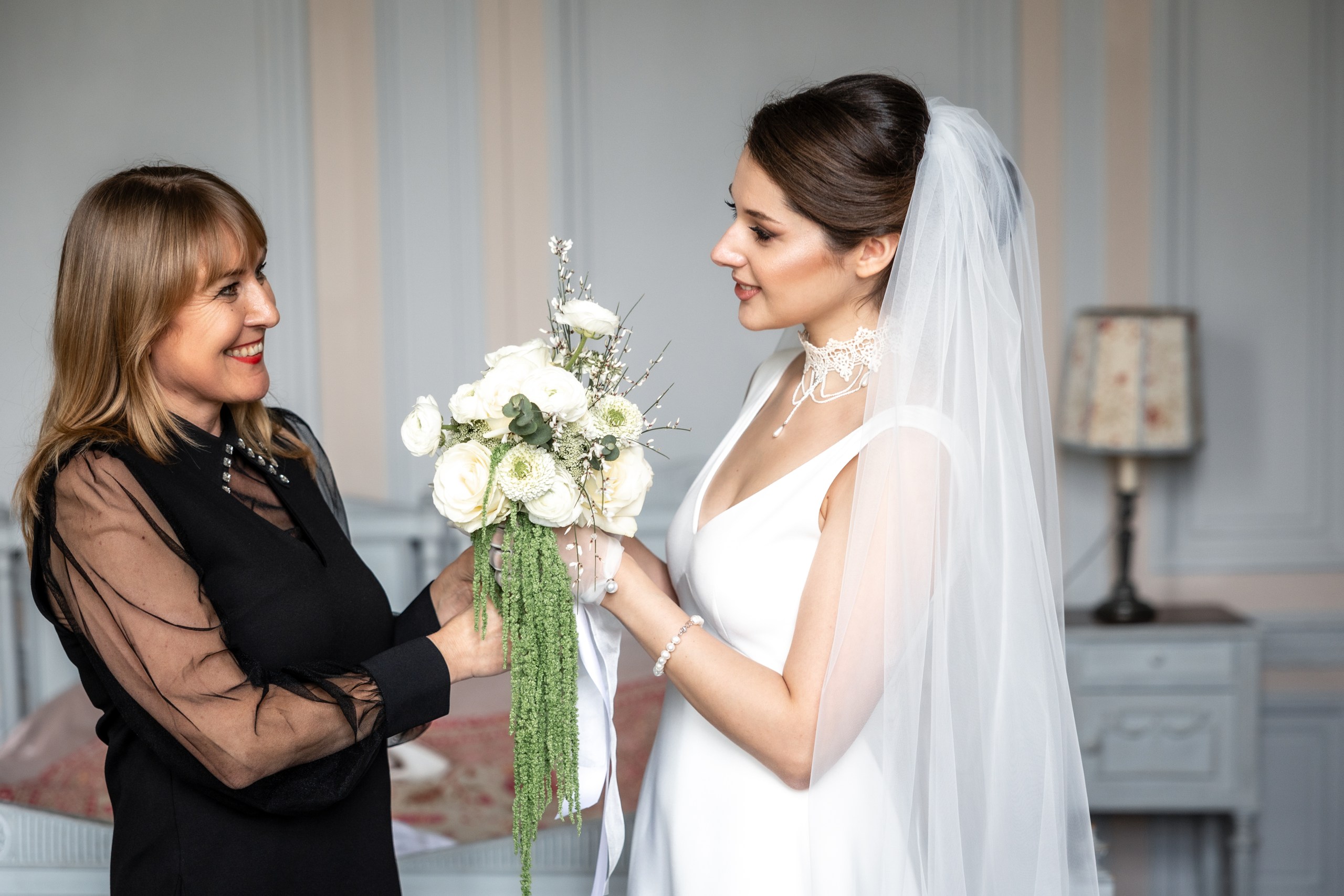 The bride receiving her bouquet before the ceremony at Château de Bonnemare