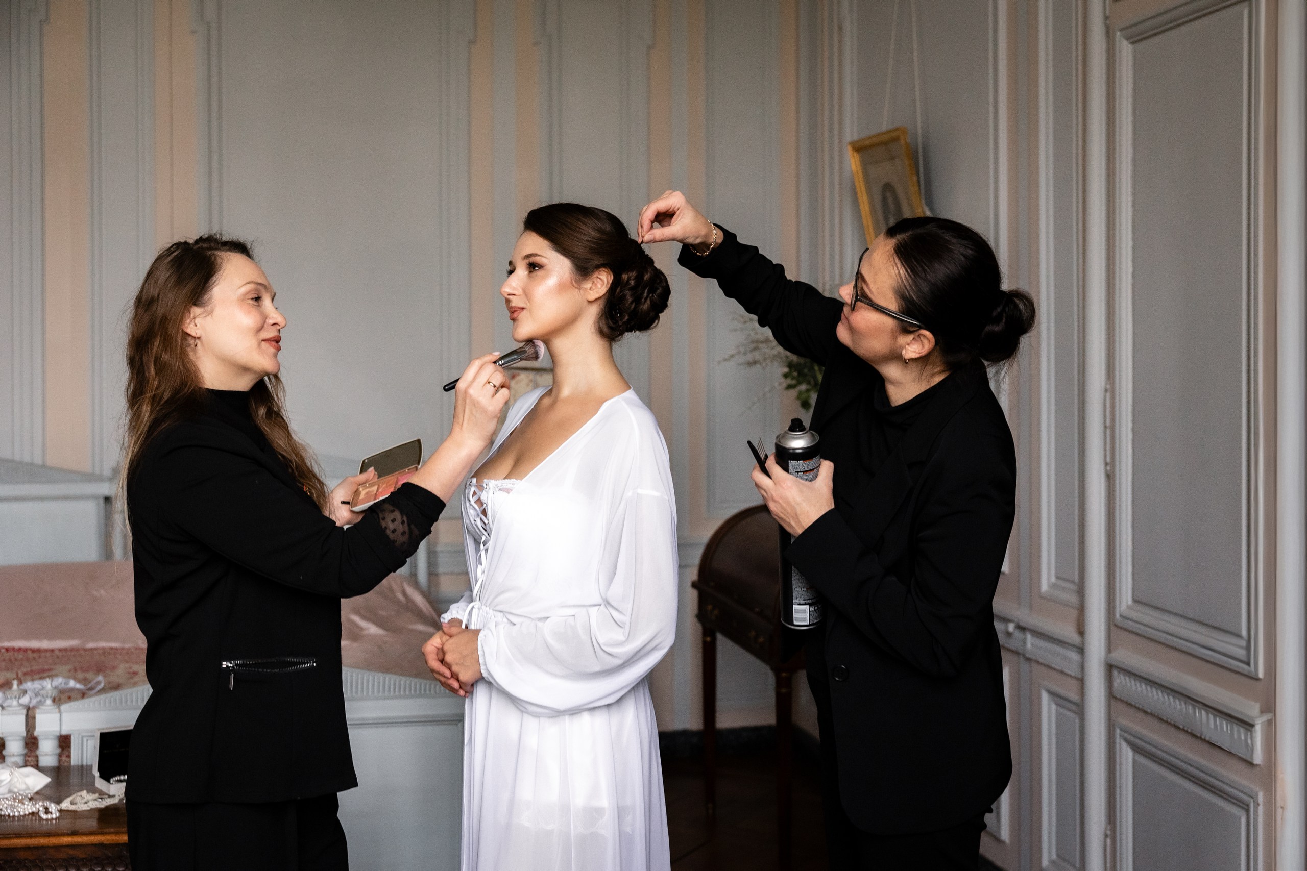 Bridal hair and makeup preparation inside a period bedroom at Château de Bonnemare